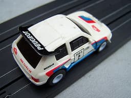 2 TOMY AURORA AFX 1:64 SCALE RALLY SLOT CARS PEUGEOT 205 TURBO & VW GOLF GTI VGC